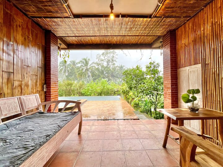 Bamboo terrace overlooking the pool at Pondok Is Oke